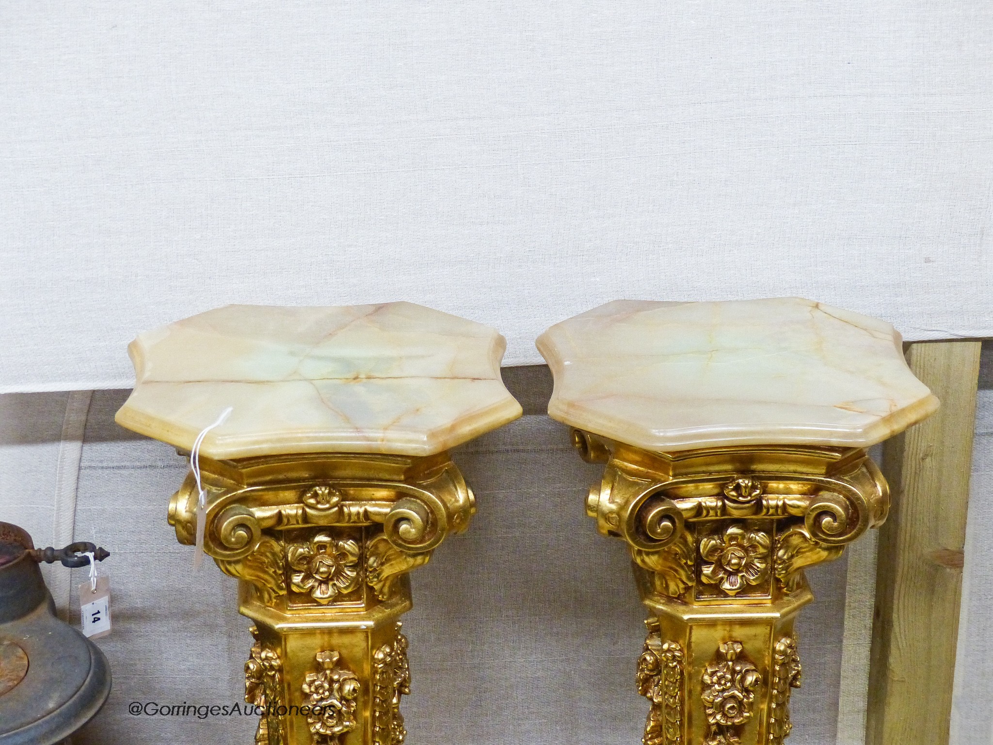 A pair of onyx top gilt pedestals, height 98cm